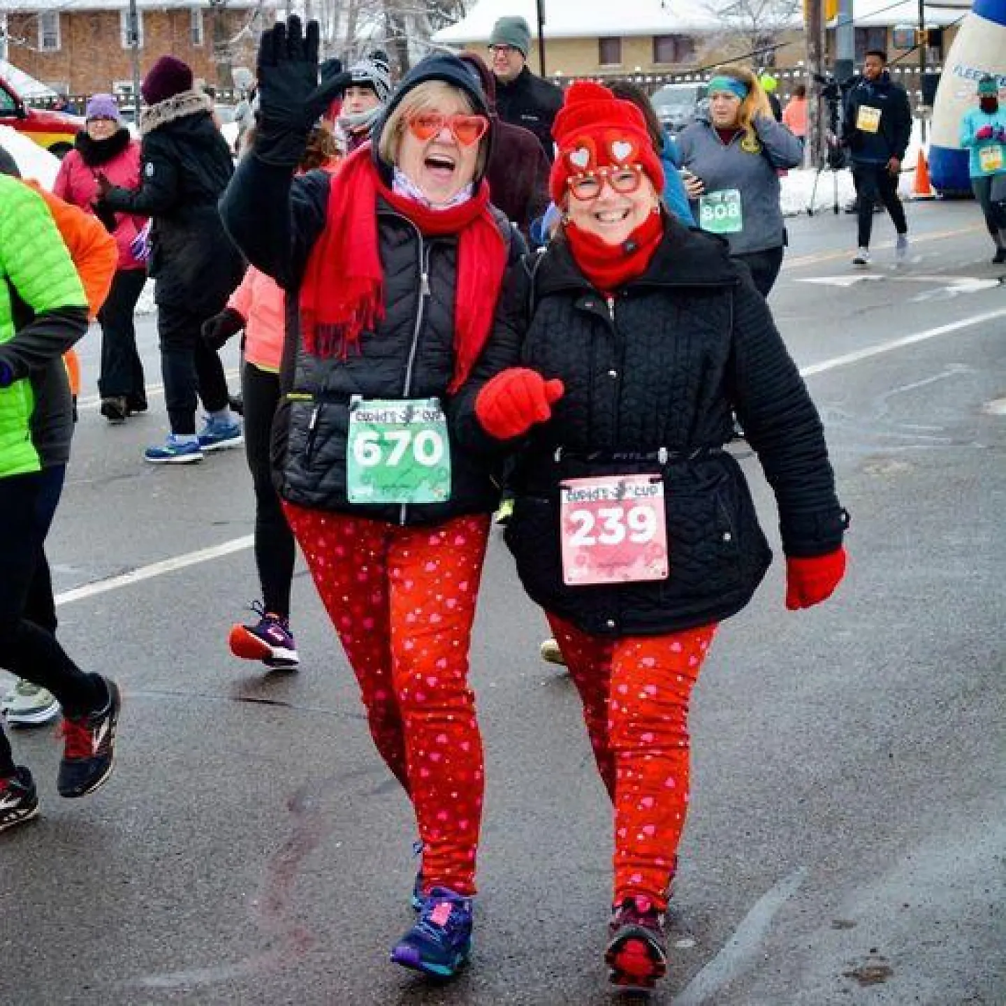 Two women participate in a Cupid's Day 5K. 