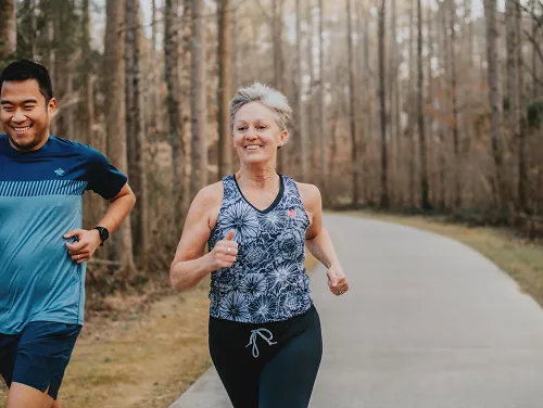 Two runners smile.