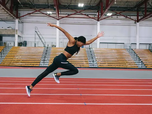 New Balance athlete Gabby Thomas runs on a track after signing a professional contract