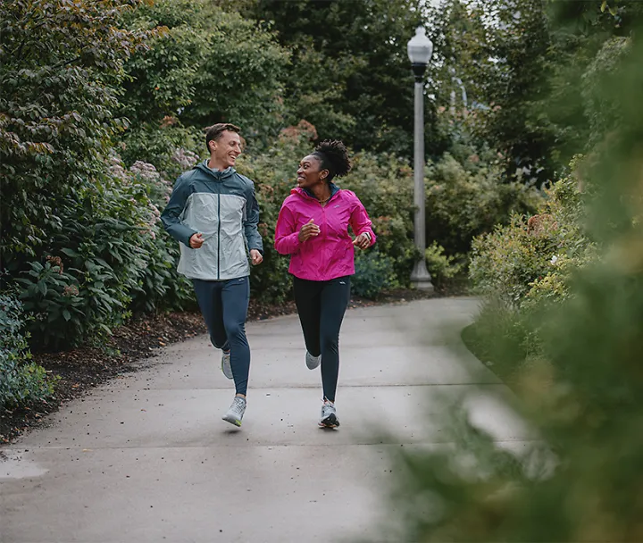 Man and woman running on park path