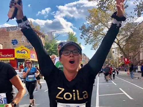 Zoilabella Calo Smiles and holds out her arms as she runs