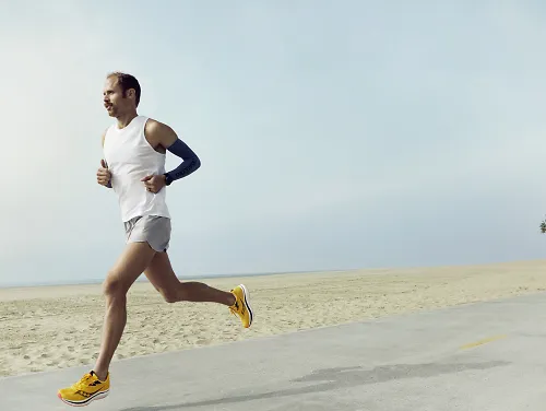 A man running by himself on a road