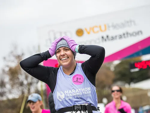 A woman smiles as she crossed the finish line of the Richmond Marathon.