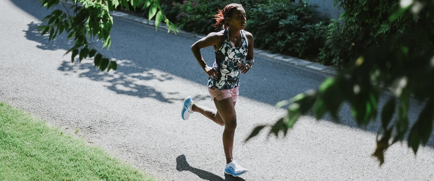 A woman runs fast on a path alone