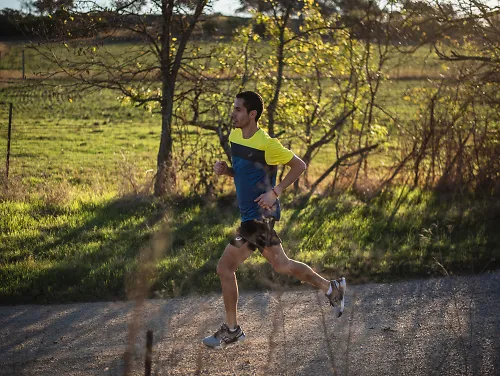 A runner wearing men's running shorts while on a trail