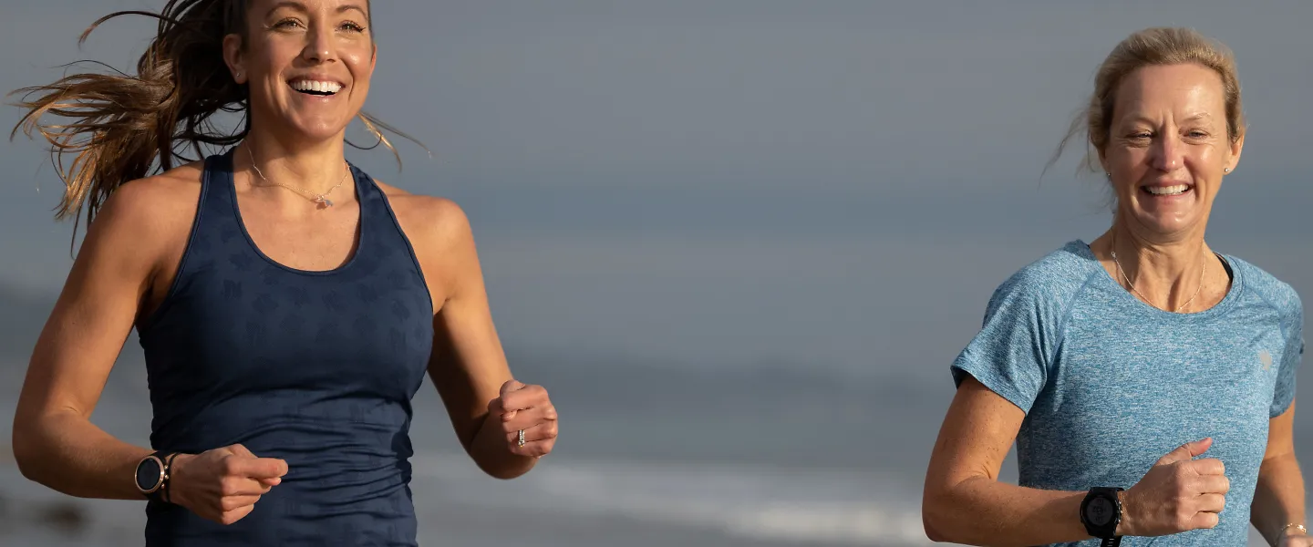 rabbit co-founders Monica DeVreese and Jill Deering run together on a beach