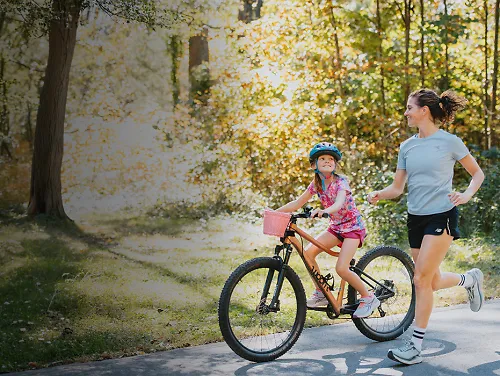 Mother running alongside daughter riding bike - mother’s day gifts for runners women