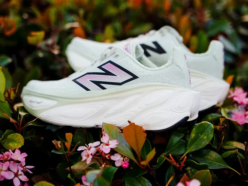 The New Balance More v5 sits on a bed of flowers.