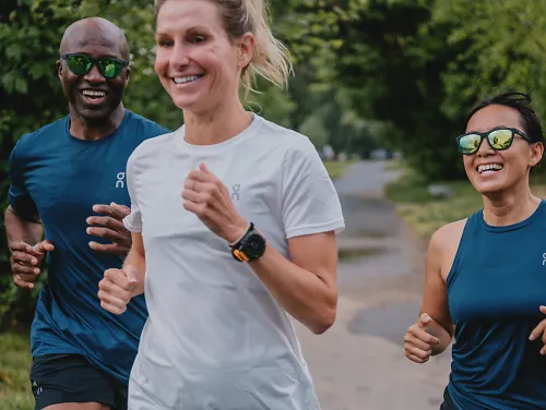 A group of runners run in sync with their GPS watches. 