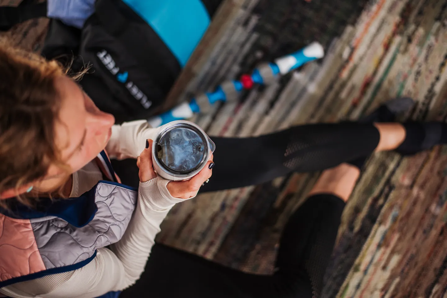 A runner sits next to an addaday Pro Roller massage stick after a run