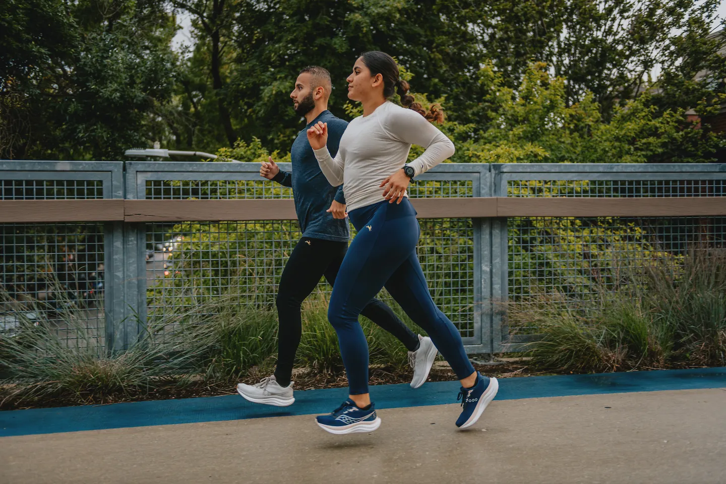 Two runners in stride together