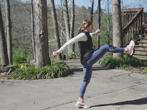Woman performing leg swings