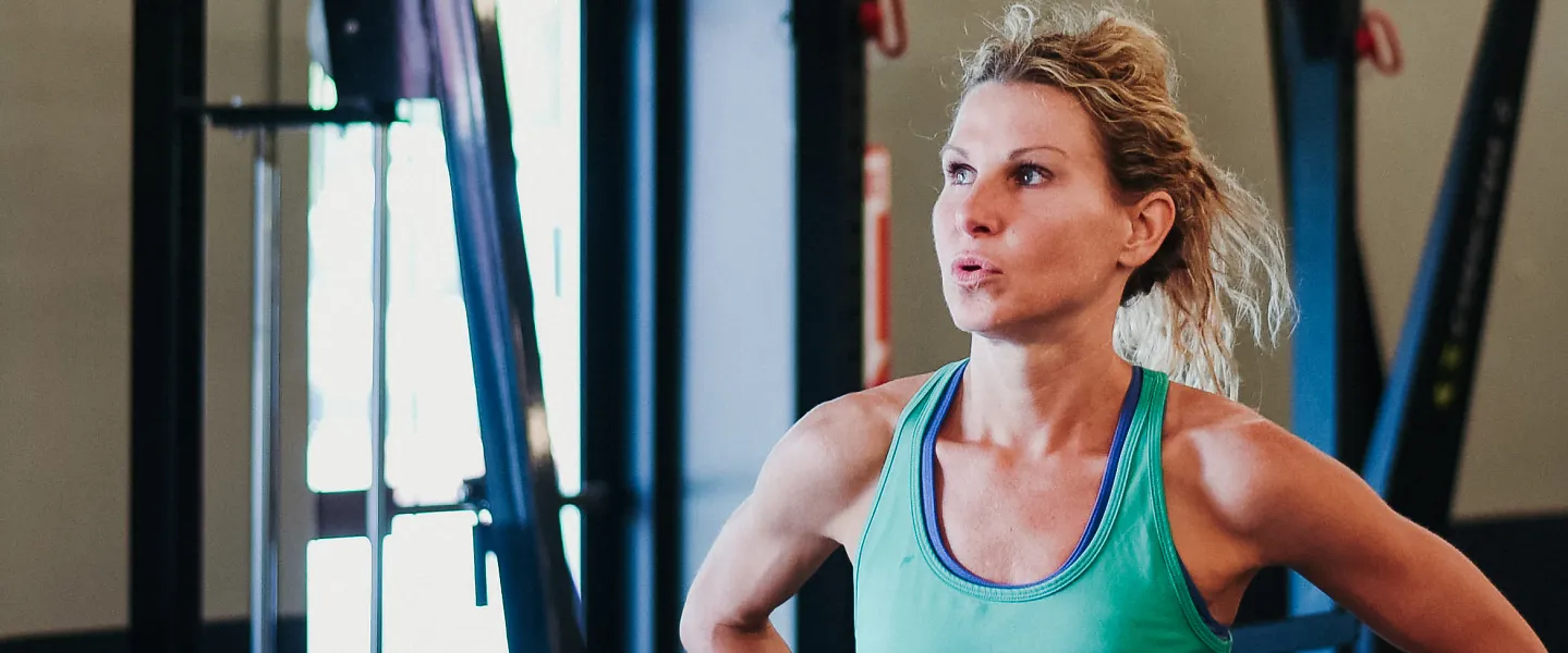 A runner at a gym takes a break between sets