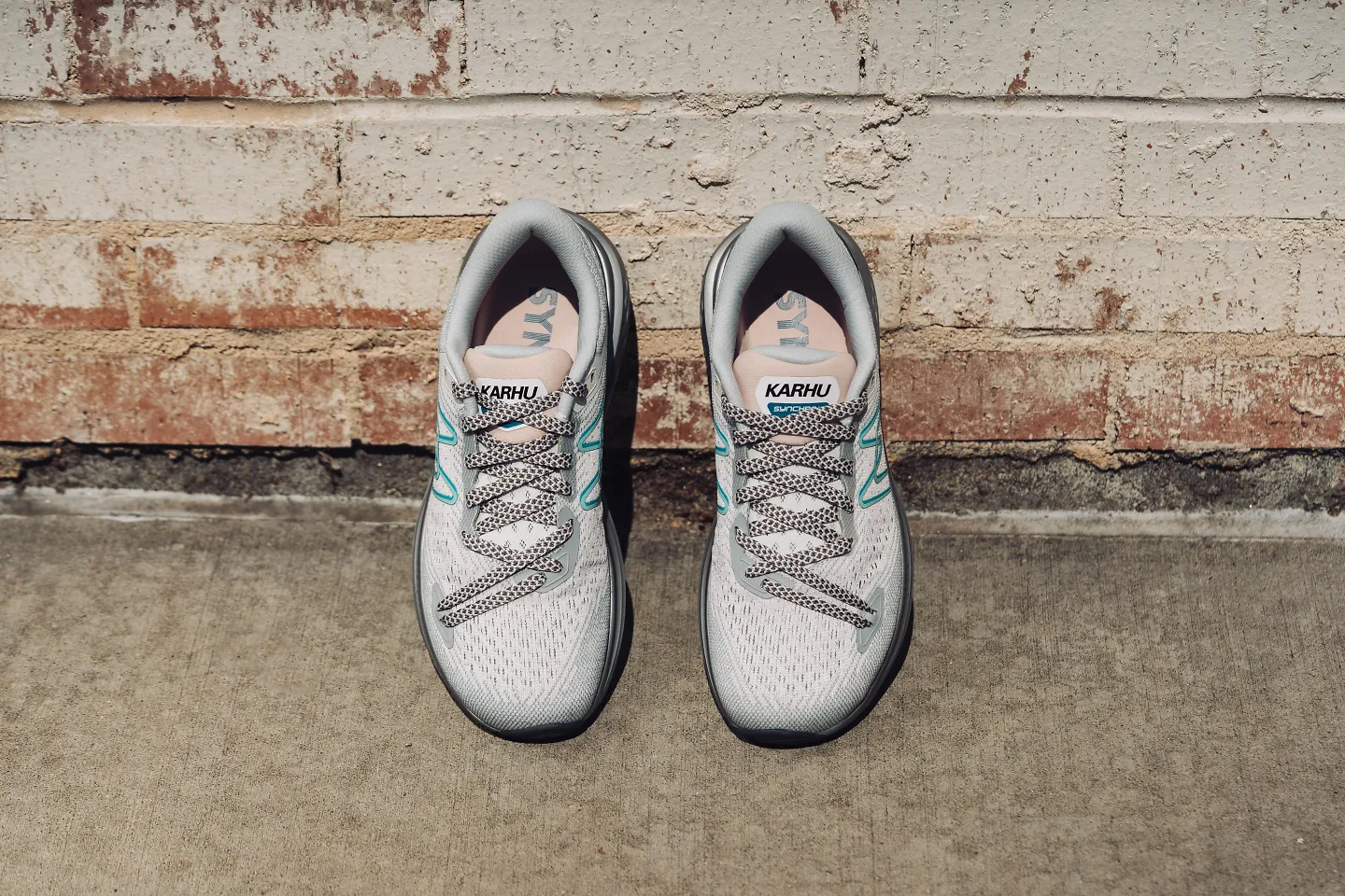 A pair of women's Karhu Synchron sits propped up against a wall.