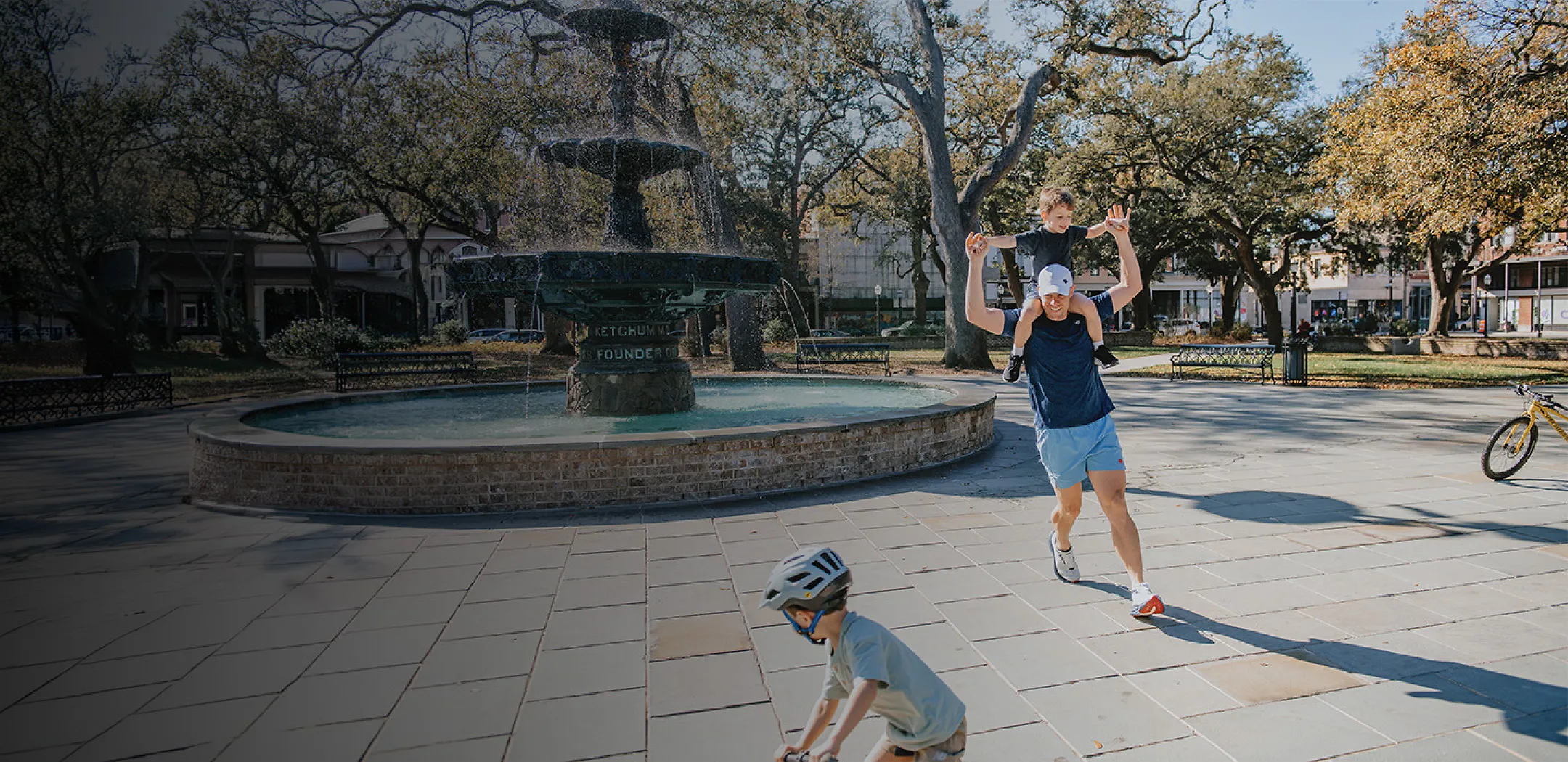 Father running with son on shoulders