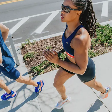 overhead view of a woman running and a man running action shot