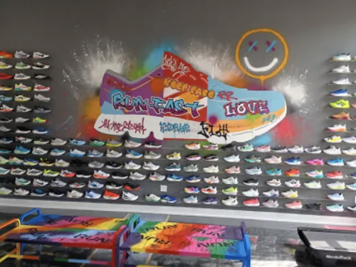 A running shoe wall and shoe mural