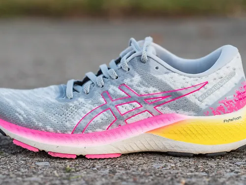 The ASICS GEL-Kayano Lite sitting on pavement