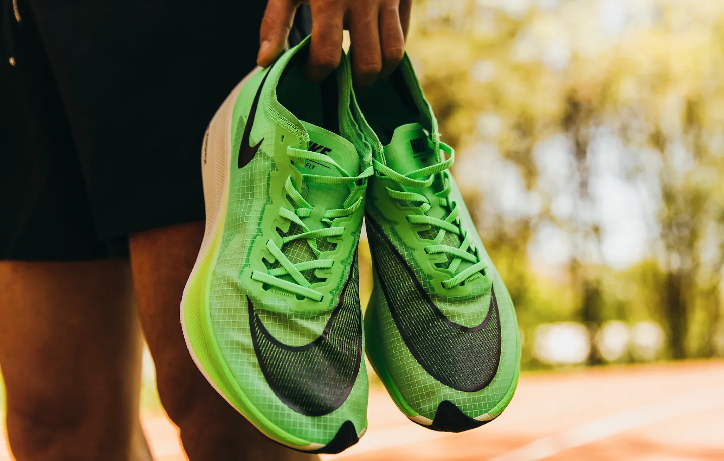 A runner hold a pair of Nike shoes, part of the best running shoe brands