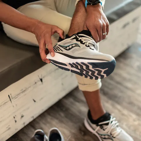 Customer trying on a pair of Saucony shoes