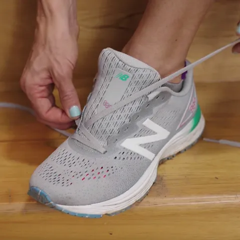 A runner demonstrates the diagonal lacing technique for running shoes