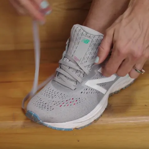 A runner demonstrates the diagonal lacing technique for running shoes