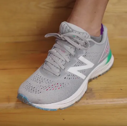 A runner demonstrates the diagonal lacing technique for running shoes