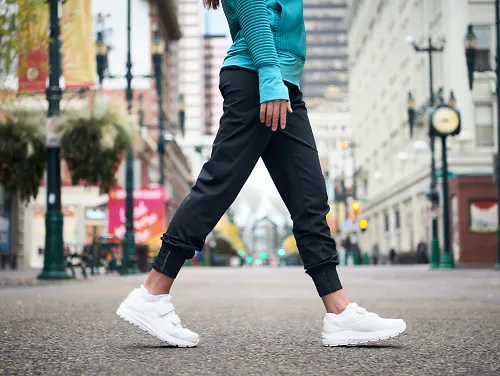 Woman walking in white Brooks Addiction Walkers