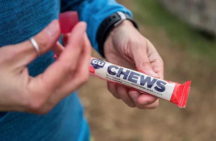 A runner eating a GU Energy Chew