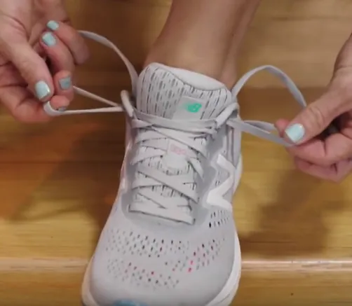 A runner demonstrates how to fo the heel lock lacing technique