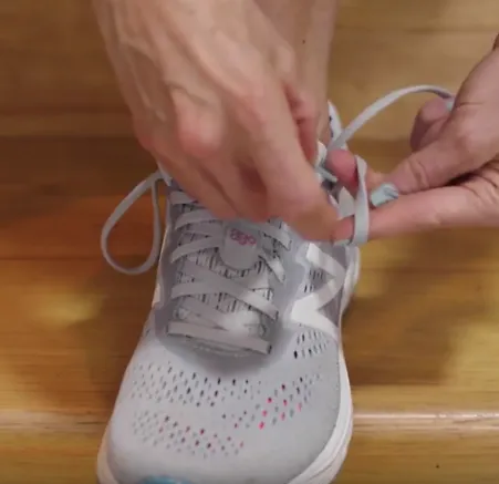 A runner demonstrates how to fo the heel lock lacing technique
