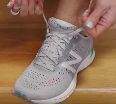 A runner demonstrates how to fo the heel lock lacing technique