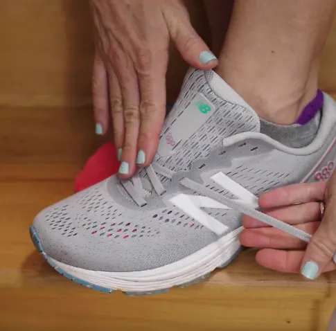 A runner demonstrates the high instep lacing technique