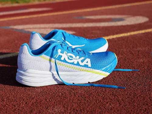 A pair of the HOKA Rocket X running shoes on a track