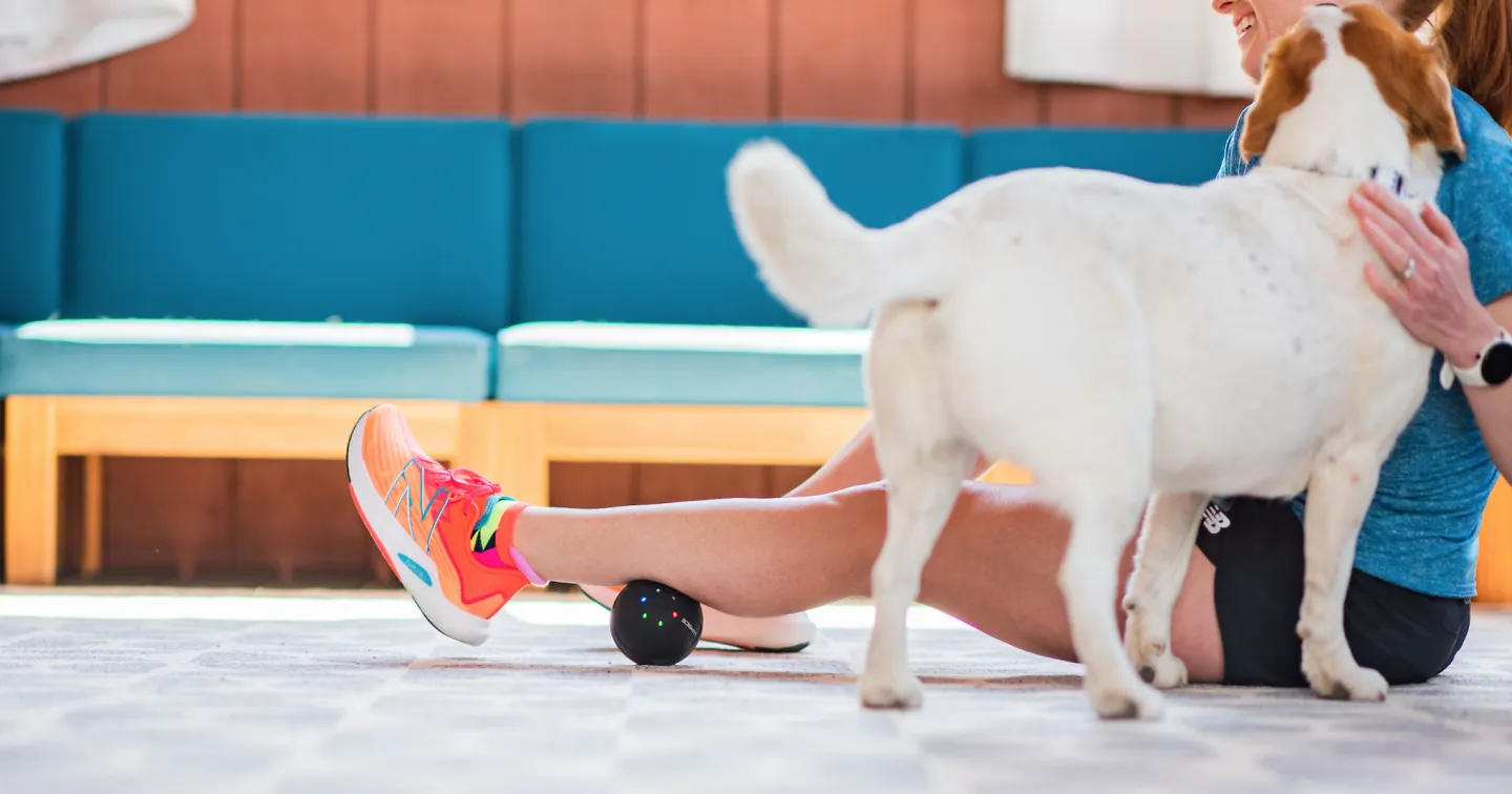 A woman using the Hyperice Hypersphere Mini