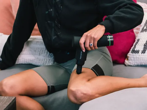 A runner using the Hypervolt GO on her leg