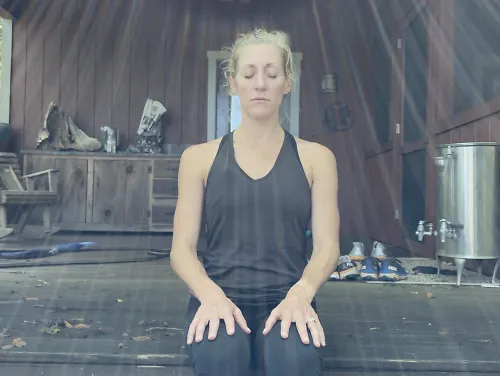 A woman sits down and relaxes.