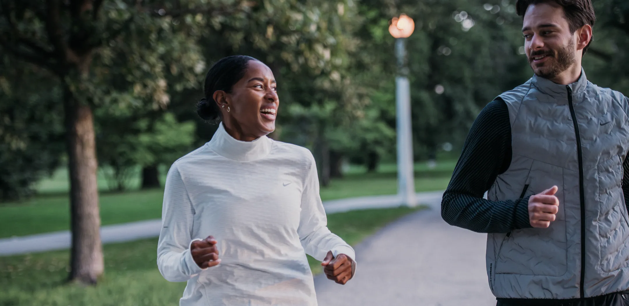 2 people running outside wearing warm clothing