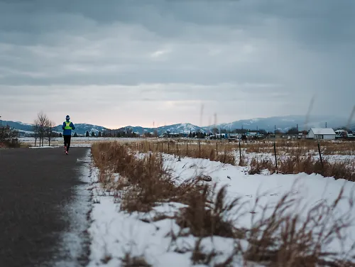 A man runs during an early winter morning