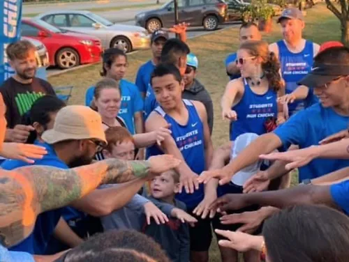 A group of young runners cheer during Students Run Chicago practice