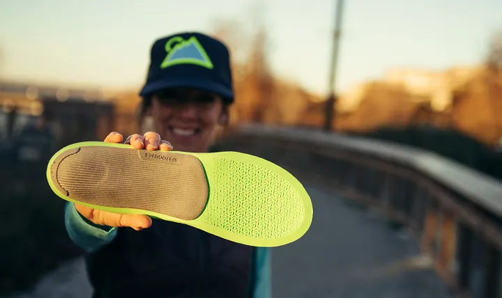 A woman holding a Superfeet ME3D insole