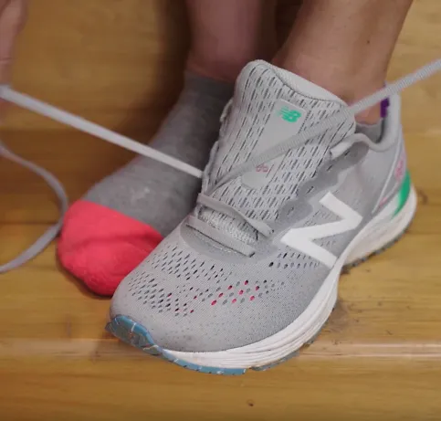 A runner demonstrates the wide feet lacing technique for running shoes