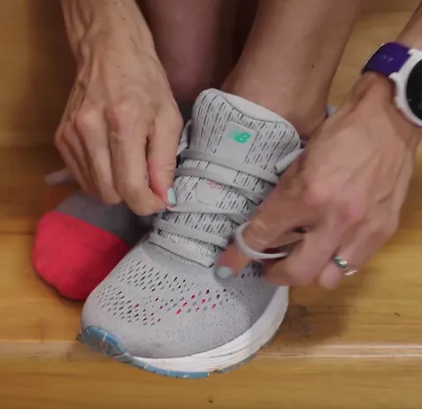 A runner demonstrates the wide feet lacing technique for running shoes