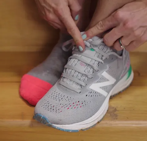 A runner demonstrates the wide feet lacing technique for running shoes